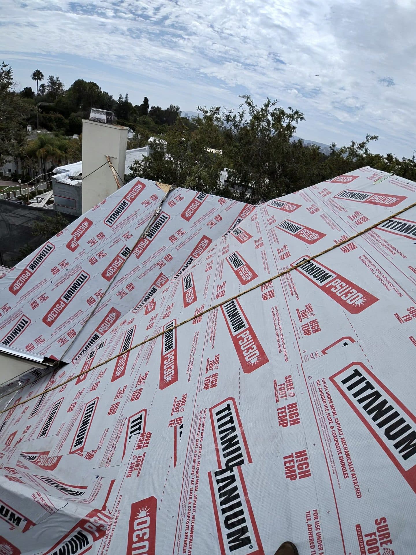 Titanium PSU30 synthetic underlayment installed on pitched roof deck | Roof Replacement Inc Titanium PSU30 synthetic underlayment installed on pitched roof deck — Roof Replacement Inc