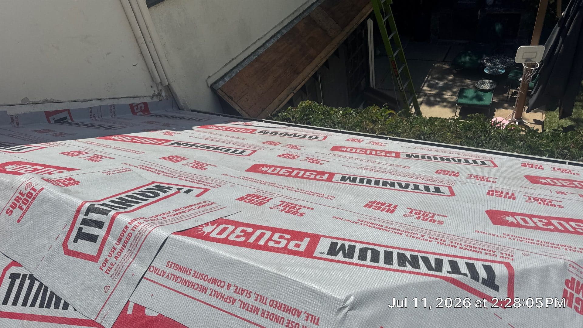 Titanium PSU30 synthetic underlayment installed on low-slope roof deck | Roof Replacement Inc Titanium PSU30 synthetic underlayment installed on low-slope roof deck — Roof Replacement Inc