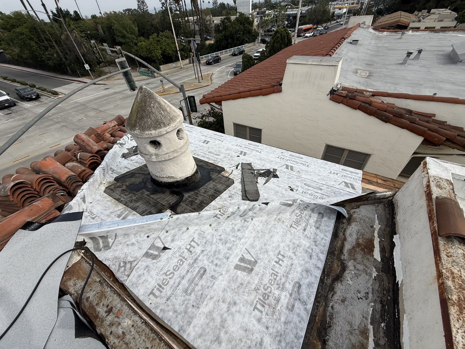 Roof deck with TileSeal HT underlayment, chimney, stacked clay tiles | Roof Replacement Inc Roof deck with TileSeal HT underlayment, chimney, stacked clay tiles — Roof Replacement Inc