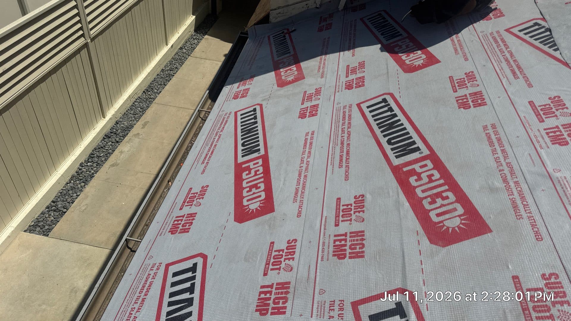 Titanium PSU30 synthetic roofing underlayment installed on low-slope roof | Roof Replacement Inc Titanium PSU30 synthetic roofing underlayment installed on low-slope roof — Roof Replacement Inc