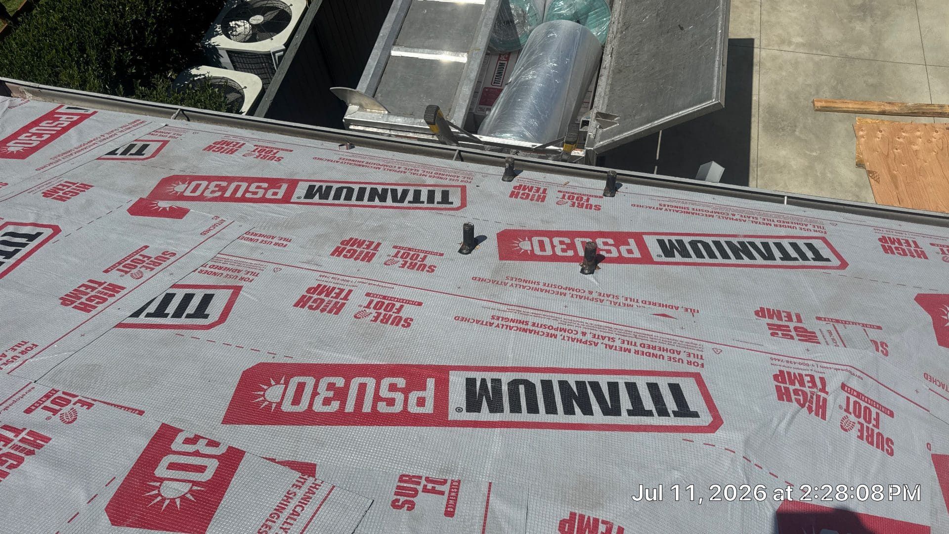 Titanium PSU30 synthetic underlayment installed on roof deck with pipe penetrations | Roof Replacement Inc Titanium PSU30 synthetic underlayment installed on roof deck with pipe penetrations — Roof Replacement Inc