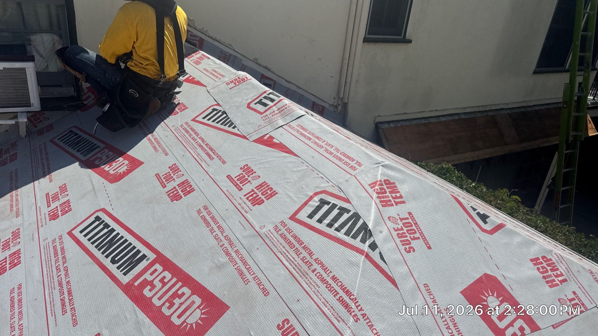 Roofer installs Titanium PSU30 underlayment on sloped roof deck | Roof Replacement Inc Roofer installs Titanium PSU30 underlayment on sloped roof deck — Roof Replacement Inc
