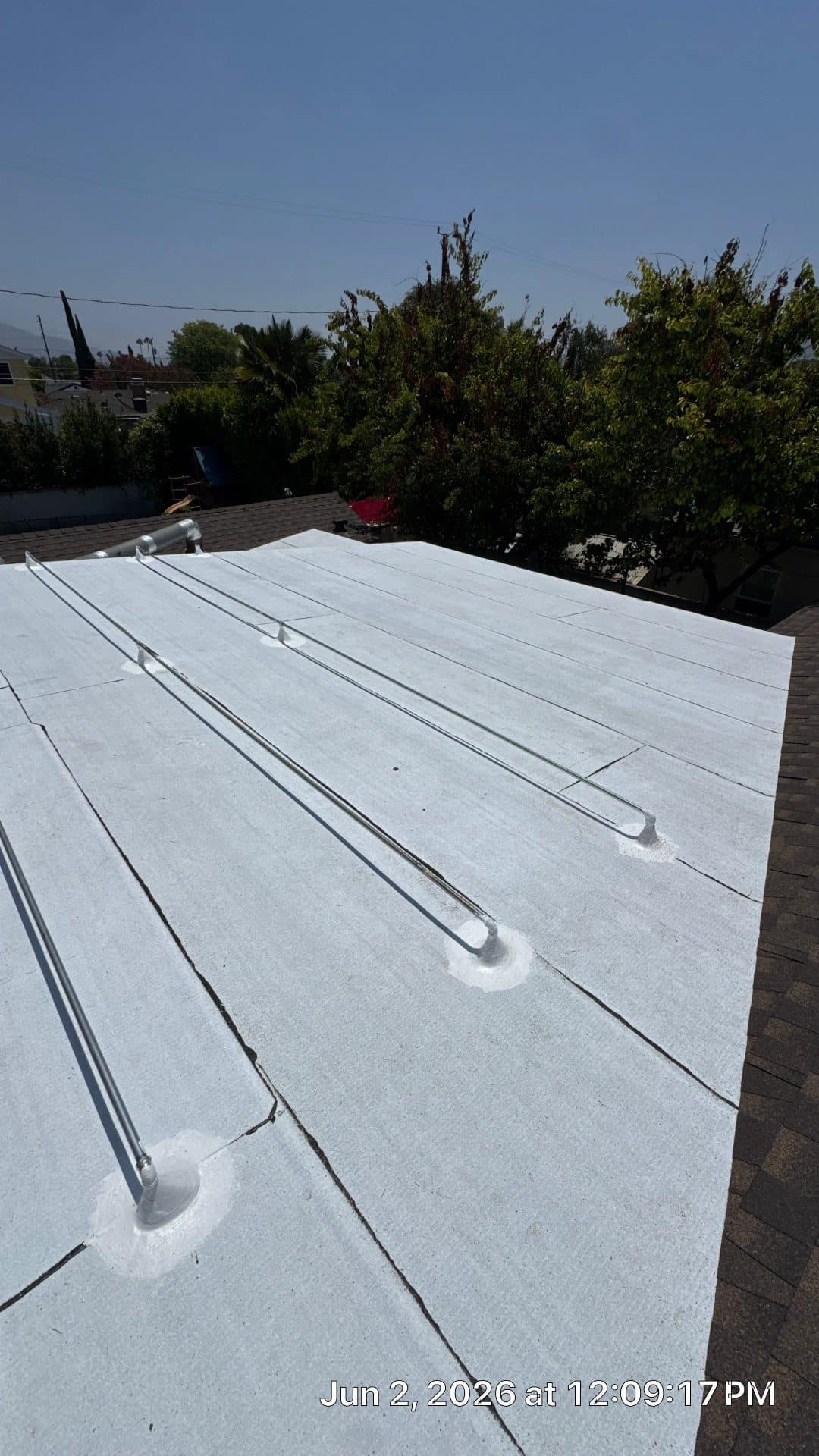 White TPO flat roof with metal conduit runs and pipe penetrations | Roof Replacement Inc white TPO flat roof with metal conduit runs and pipe penetrations — Roof Replacement Inc