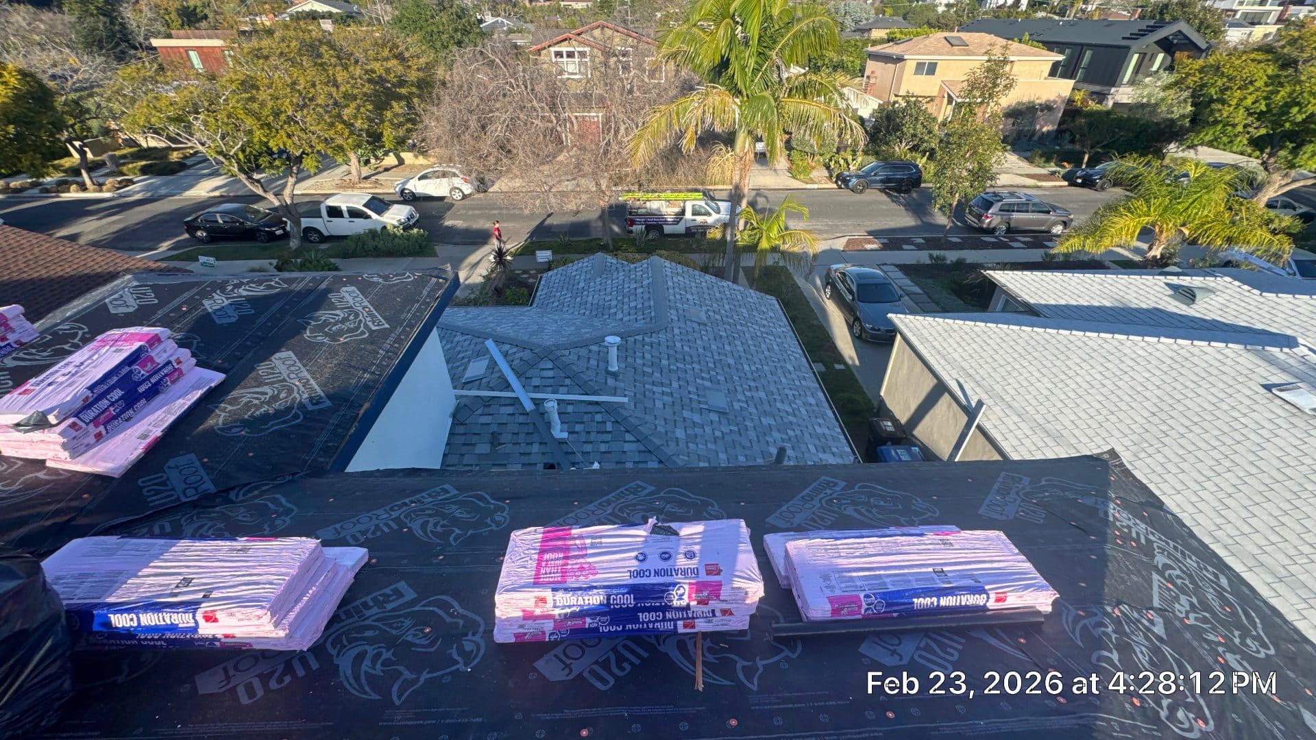 Roof deck with felt underlayment and Duration Cool shingle bundles staged | Roof Replacement Inc Roof deck with felt underlayment and Duration Cool shingle bundles staged — Roof Replacement Inc