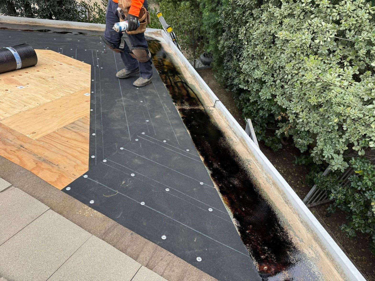White TPO cool roof membrane installed on a flat residential roof in California