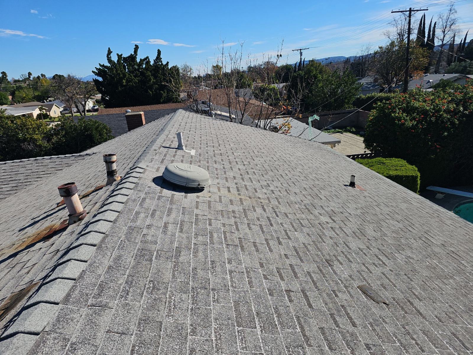 Aged asphalt shingle roof with pipe boots, attic vent, and ridge | Roof Replacement Inc Aged asphalt shingle roof with pipe boots, attic vent, and ridge — Roof Replacement Inc