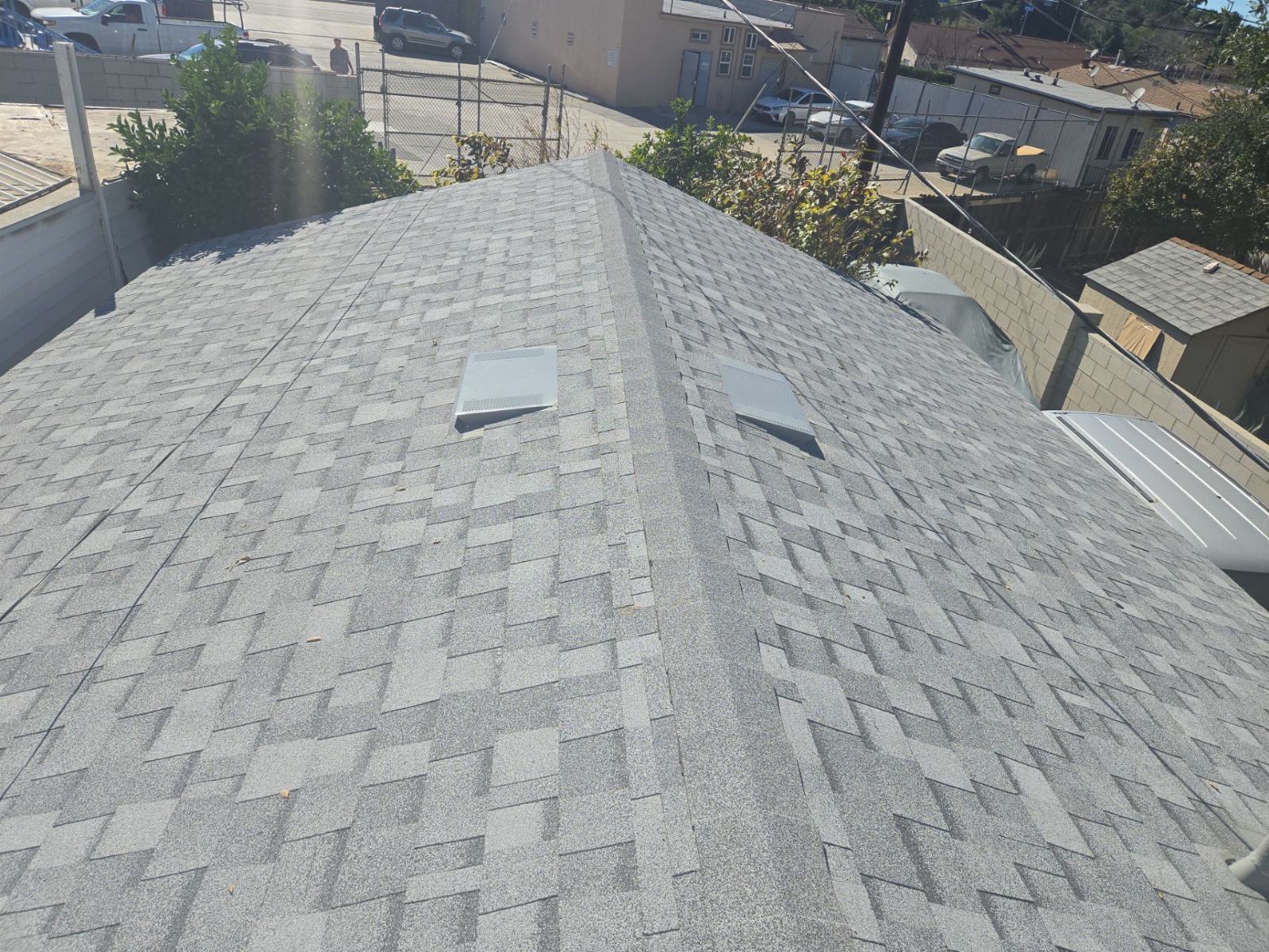 Grey asphalt shingle roof with two metal roof vents installed | Roof Replacement Inc Grey asphalt shingle roof with two metal roof vents installed — Roof Replacement Inc