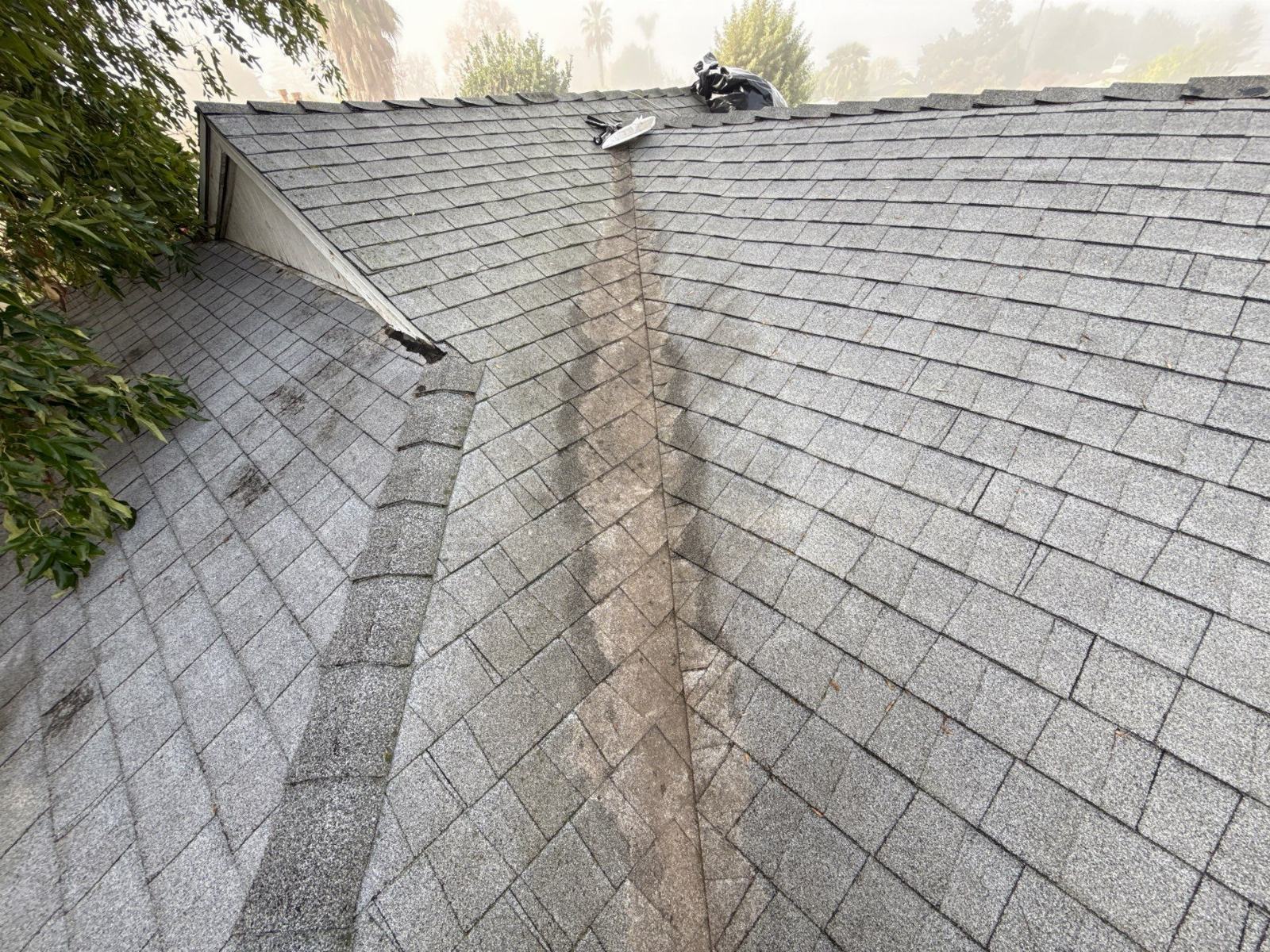 Gray asphalt shingle roof valley and hip junction with wear in San Gabriel Valley | Roof Replacement Inc Gray asphalt shingle roof valley and hip junction with wear — San Gabriel Valley — Roof Replacement Inc