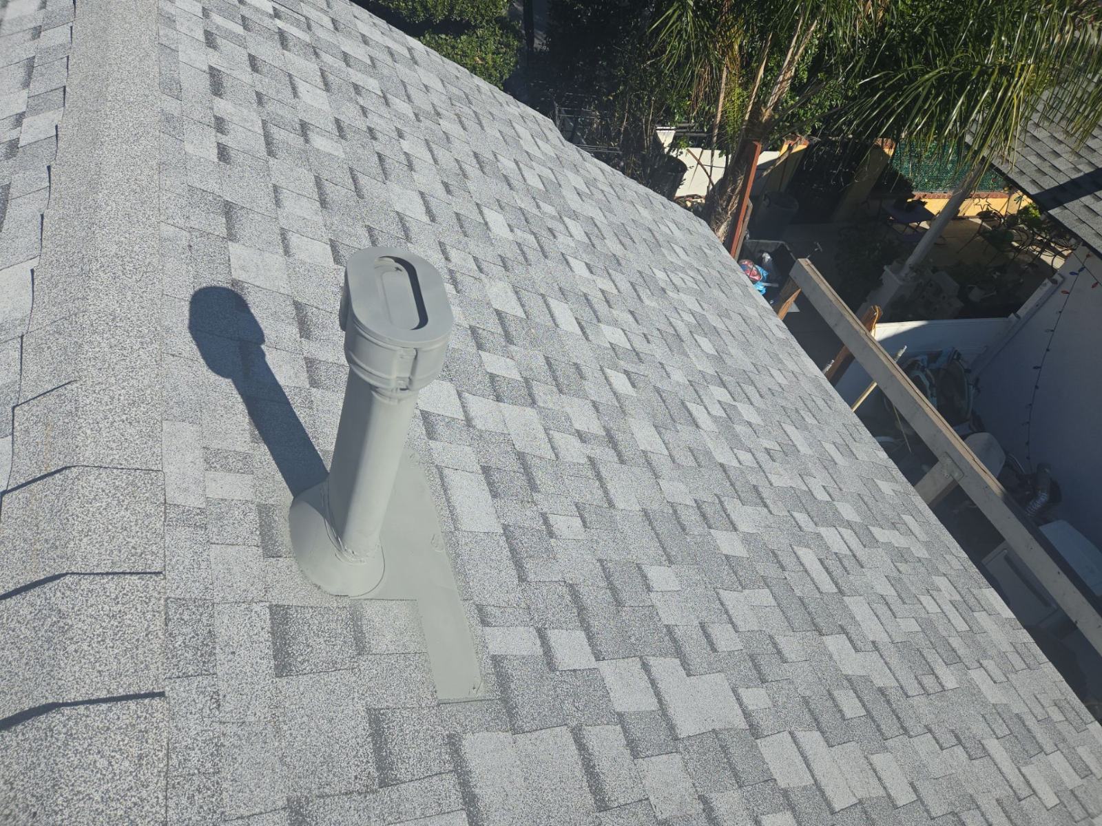 Gray asphalt shingle roof with plumbing vent pipe flashing | Roof Replacement Inc Gray asphalt shingle roof with plumbing vent pipe flashing — Roof Replacement Inc