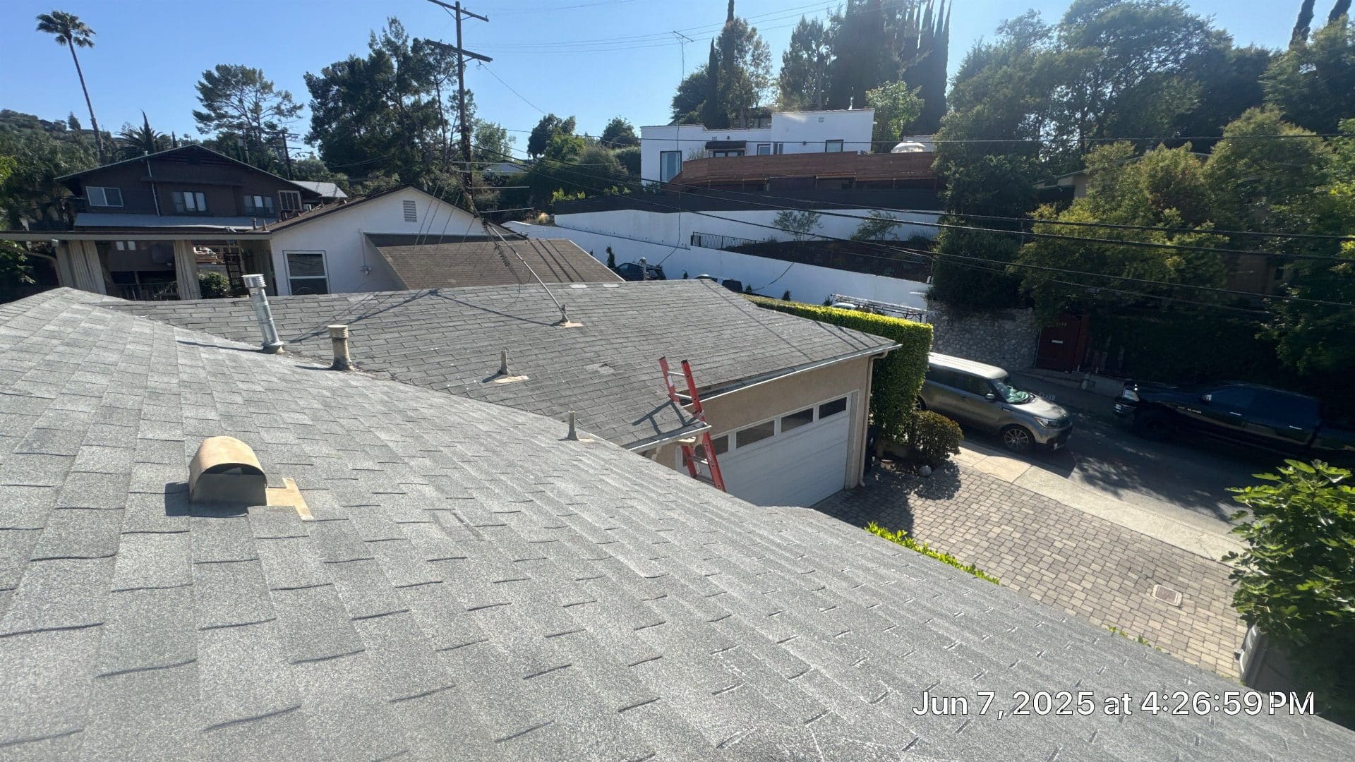 Asphalt shingle roof with vents, garage roof, red ladder in Highland Park | Roof Replacement Inc Asphalt shingle roof with vents, garage roof, red ladder — Highland Park — Roof Replacement Inc