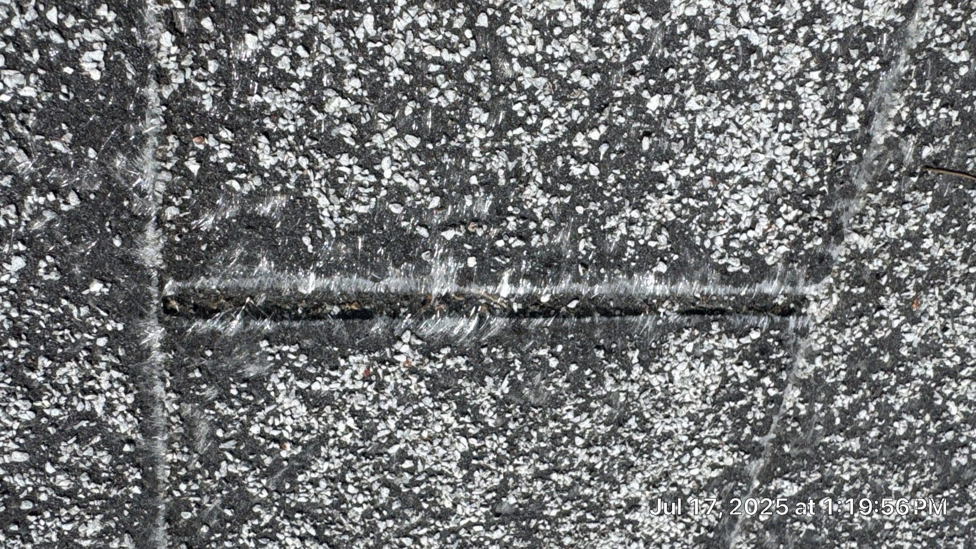 Close-up of a caulked crack on a gravel built-up flat roof in La Crescenta-Montrose | Roof Replacement Inc Close-up of a caulked crack on a gravel built-up flat roof — La Crescenta-Montrose — Roof Replacement Inc