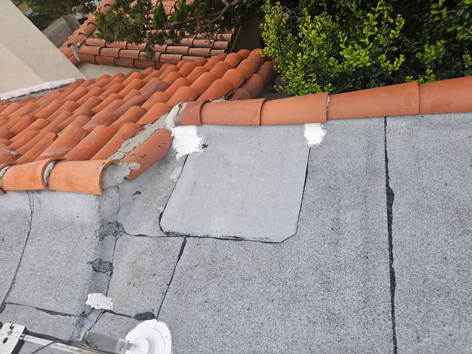 Flat cap sheet roof with patch repair beside clay tile slope in Glendale | Roof Replacement Inc Flat cap sheet roof with patch repair beside clay tile slope — Glendale — Roof Replacement Inc