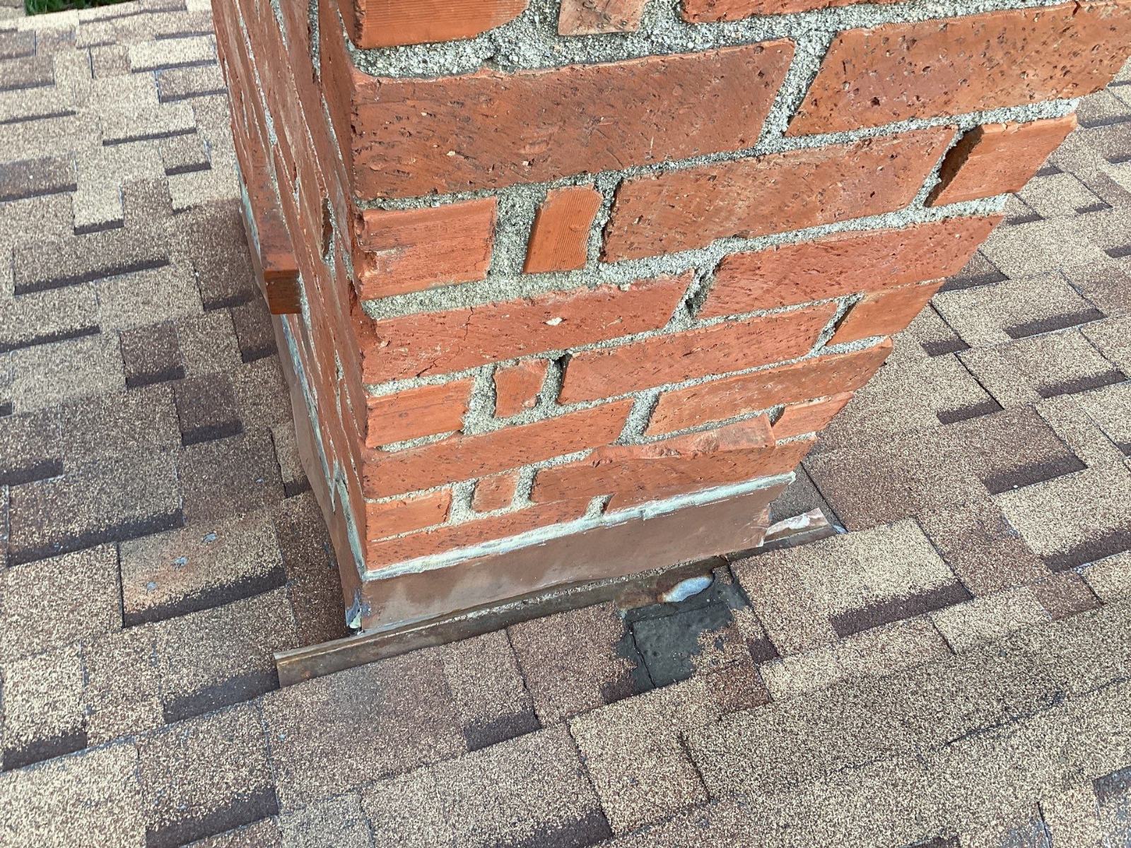 Brick chimney base with copper flashing on asphalt shingle roof in West Hills | Roof Replacement Inc Brick chimney base with copper flashing on asphalt shingle roof — West Hills — Roof Replacement Inc