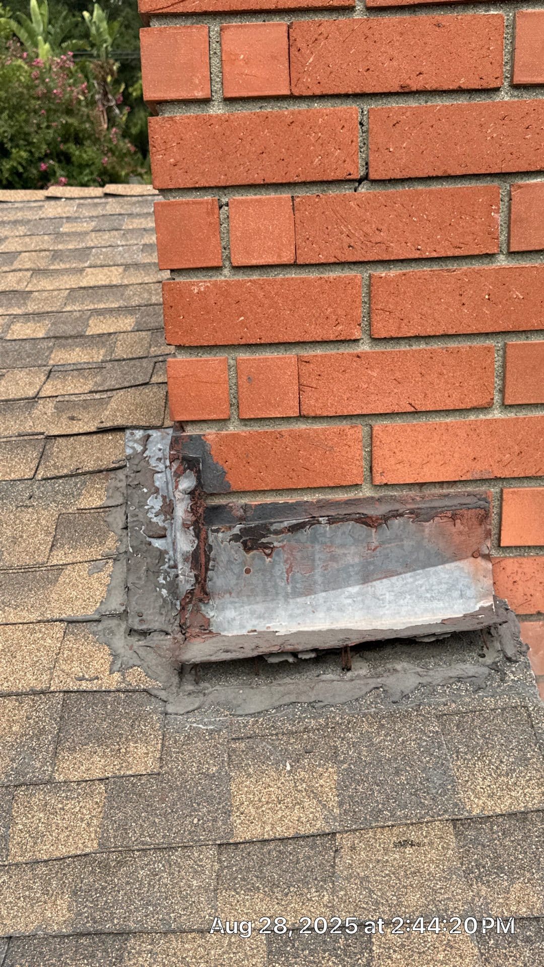 Chimney flashing repair with metal step flashing and mortar on asphalt shingle roof — Altadena — Roof Replacement Inc