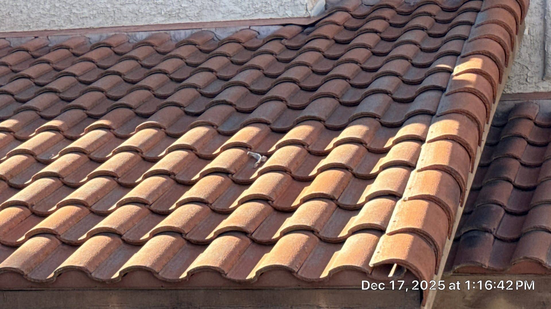 Clay S-tile roof with two-tone coloring, eave edge visible | Roof Replacement Inc Clay S-tile roof with two-tone coloring, eave edge visible — Roof Replacement Inc