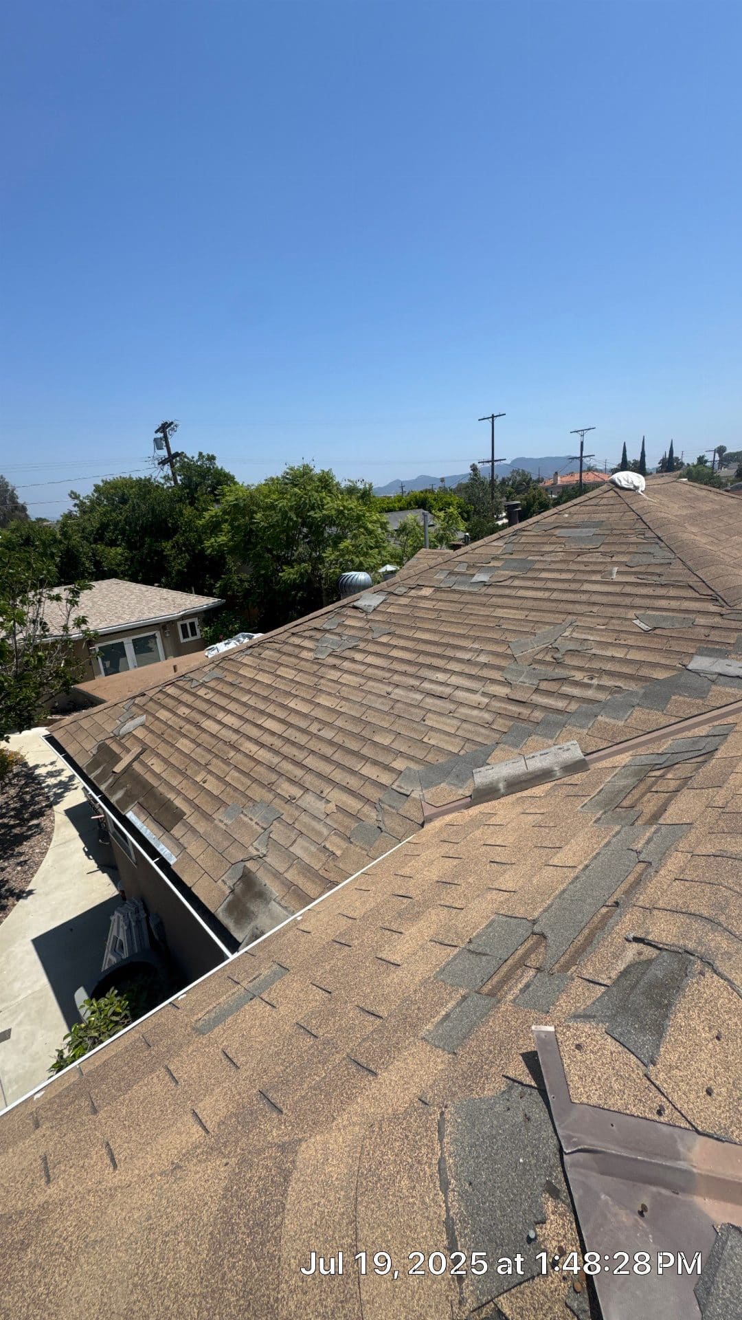 Aged asphalt shingle hip roof with missing and damaged shingles in North Hollywood | Roof Replacement Inc Aged asphalt shingle hip roof with missing and damaged shingles — North Hollywood — Roof Replacement Inc