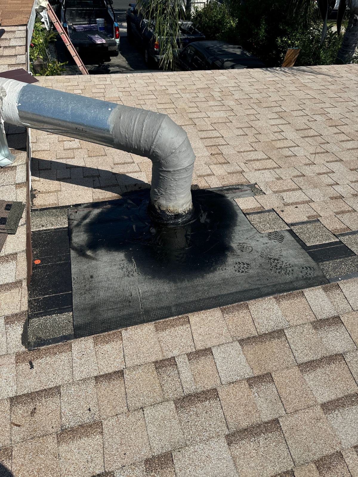Flexible duct pipe through rubber boot flashing on asphalt shingle roof in San Gabriel Valley | Roof Replacement Inc Flexible duct pipe through rubber boot flashing on asphalt shingle roof — San Gabriel Valley — Roof Replacement Inc
