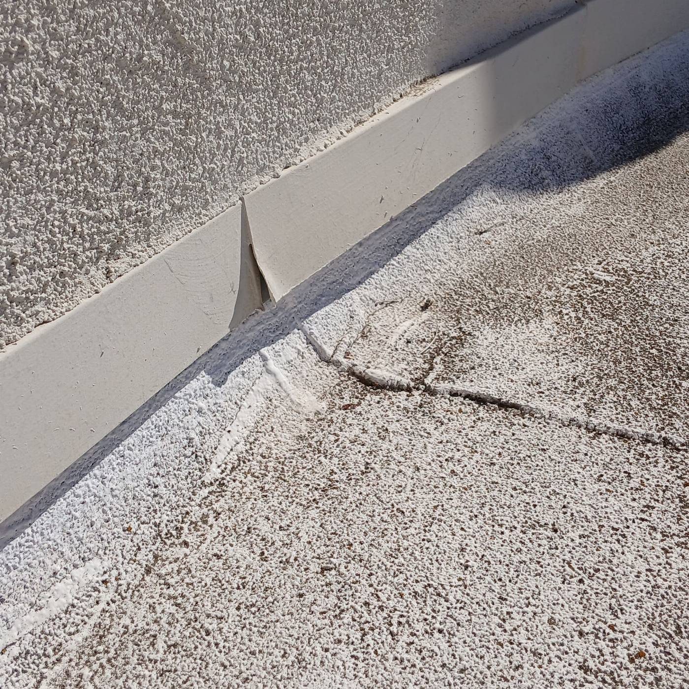 Flat roof waterproof coating with metal flashing at parapet wall base in Malibu | Roof Replacement Inc Flat roof waterproof coating with metal flashing at parapet wall base — Malibu — Roof Replacement Inc
