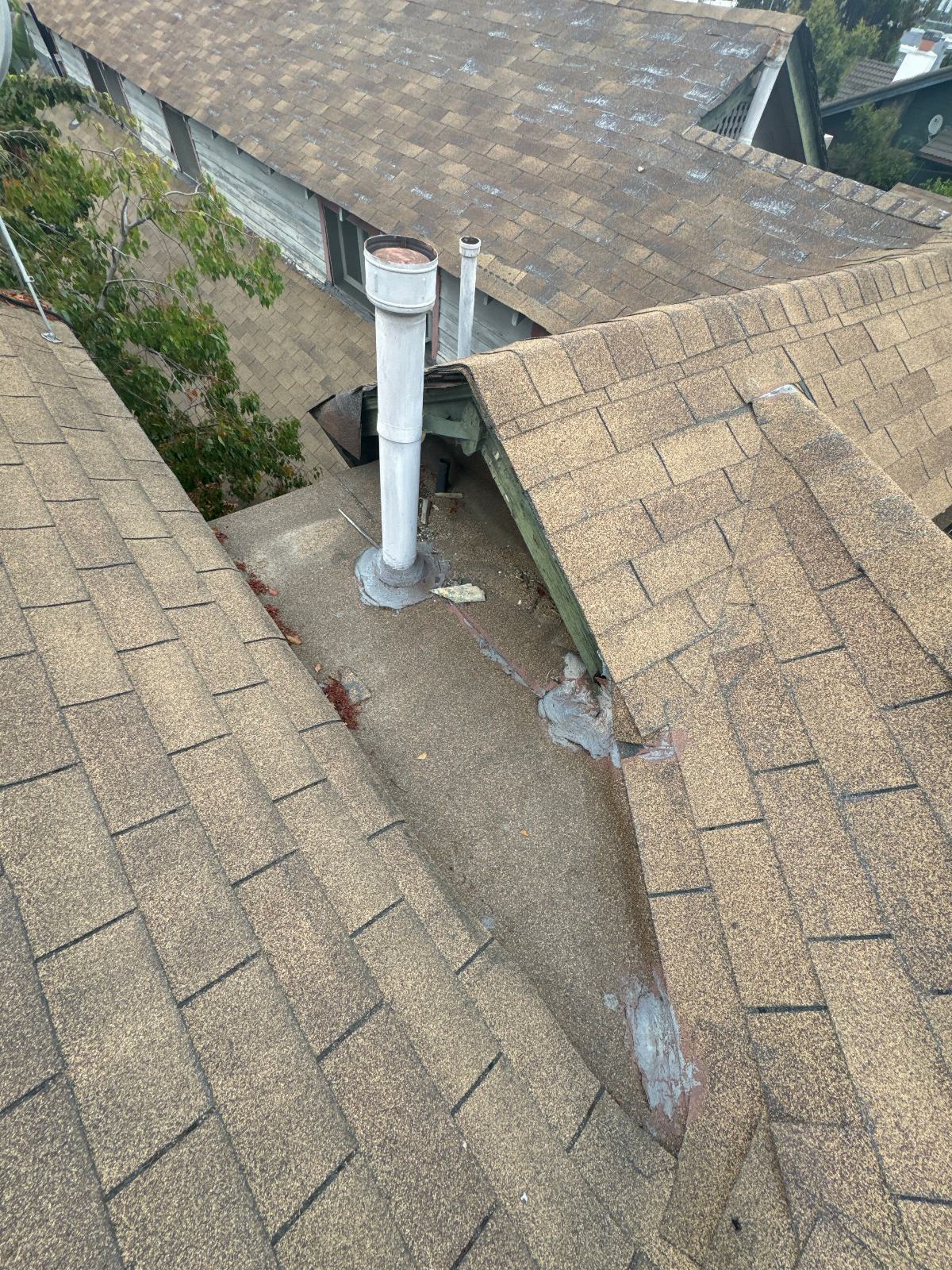 Damaged flat roof section with lifted shingles and pipe vents in Echo Park | Roof Replacement Inc Damaged flat roof section with lifted shingles and pipe vents — Echo Park — Roof Replacement Inc