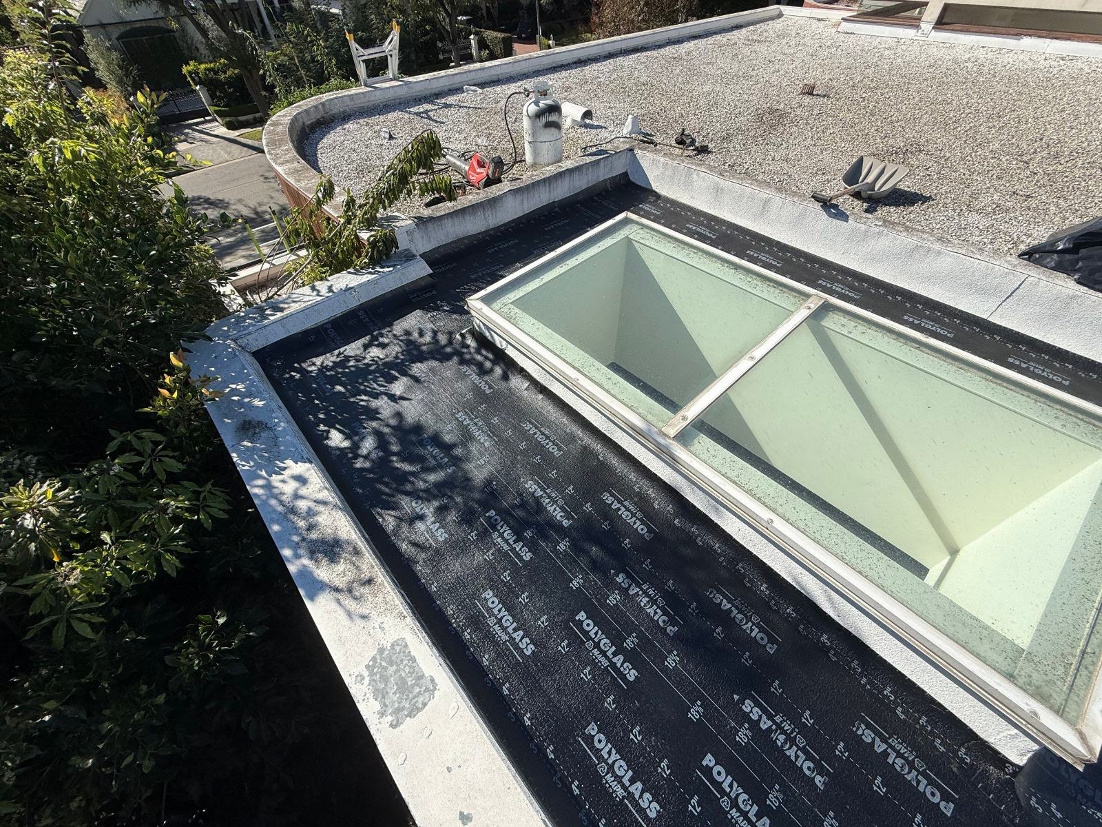 Polyglass underlayment on flat roof with skylights and gravel section in Beverly Hills | Roof Replacement Inc Polyglass underlayment on flat roof with skylights and gravel section — Beverly Hills — Roof Replacement Inc