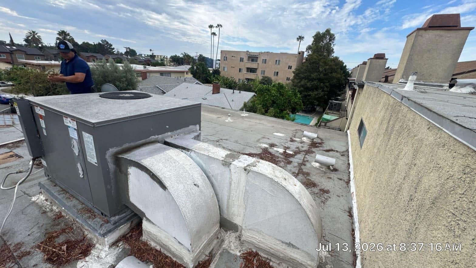 Freshly applied white elastomeric roof coating on a flat commercial roof in Southern California