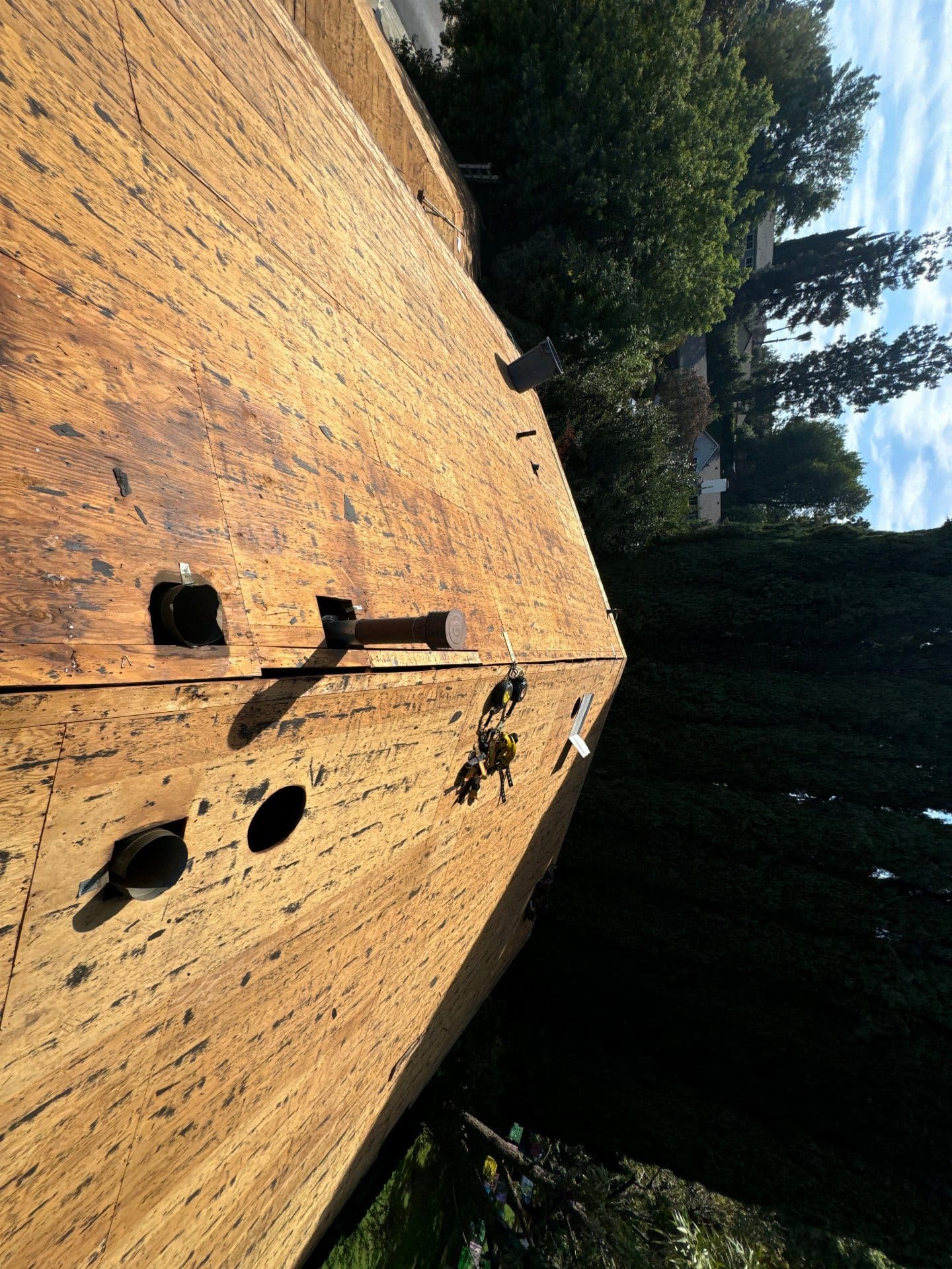 OSB roof deck sheathing with pipe penetrations and anchor point in West Hills | Roof Replacement Inc OSB roof deck sheathing with pipe penetrations and anchor point — West Hills — Roof Replacement Inc