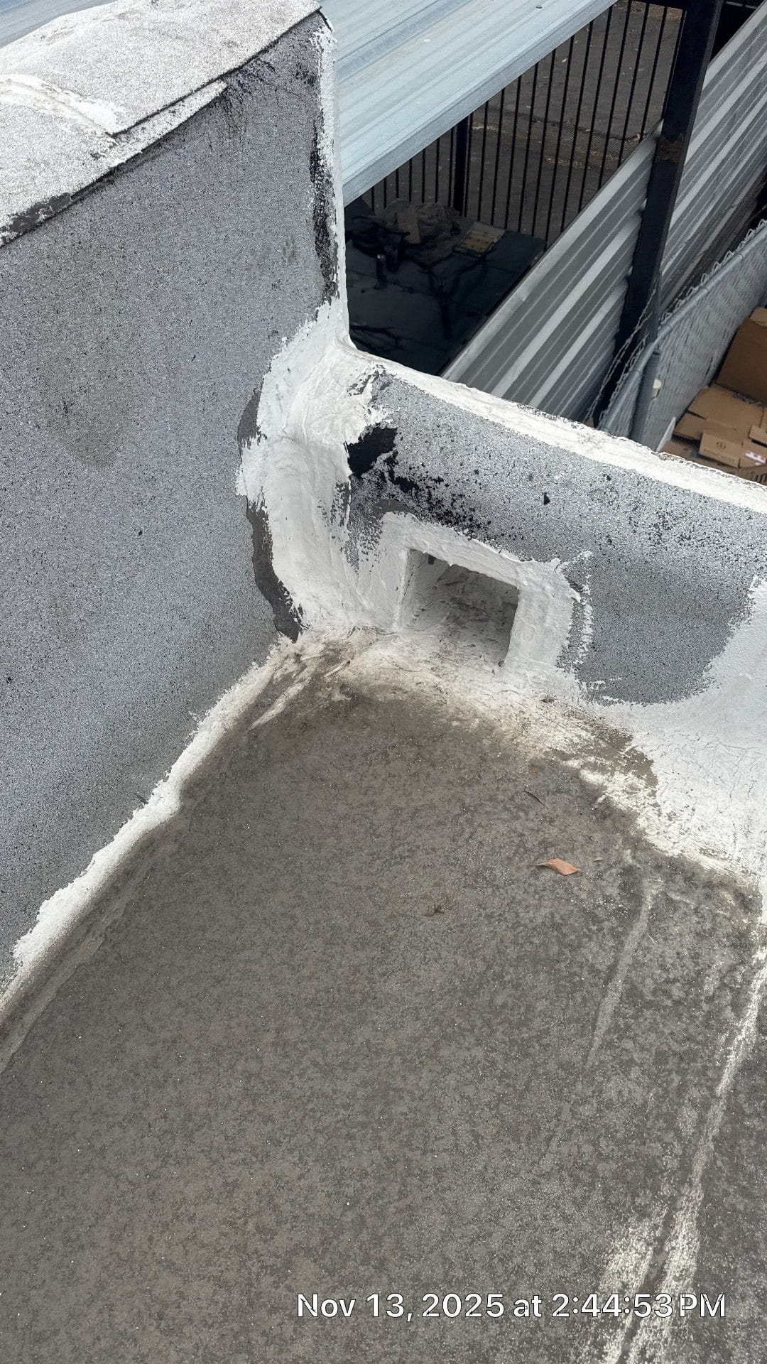 Concrete parapet corner with drain outlet and white sealant coating applied in Northridge | Roof Replacement Inc Concrete parapet corner with drain outlet and white sealant coating applied — Northridge — Roof Replacement Inc