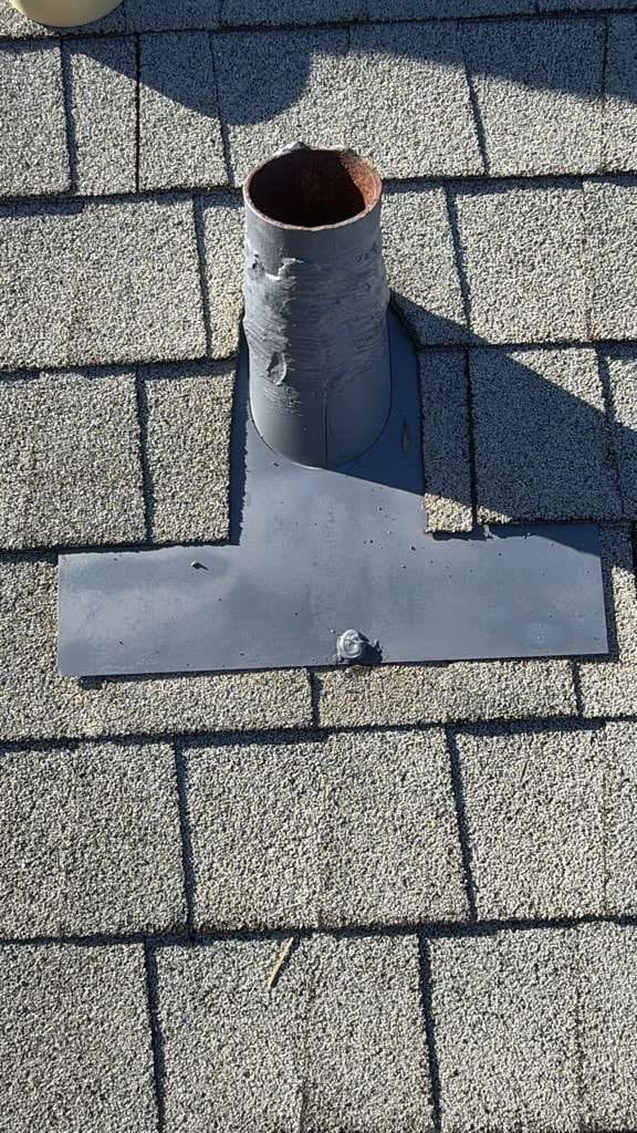 Rusted pipe boot flashing on asphalt shingle roof | Roof Replacement Inc Rusted pipe boot flashing on asphalt shingle roof — Roof Replacement Inc