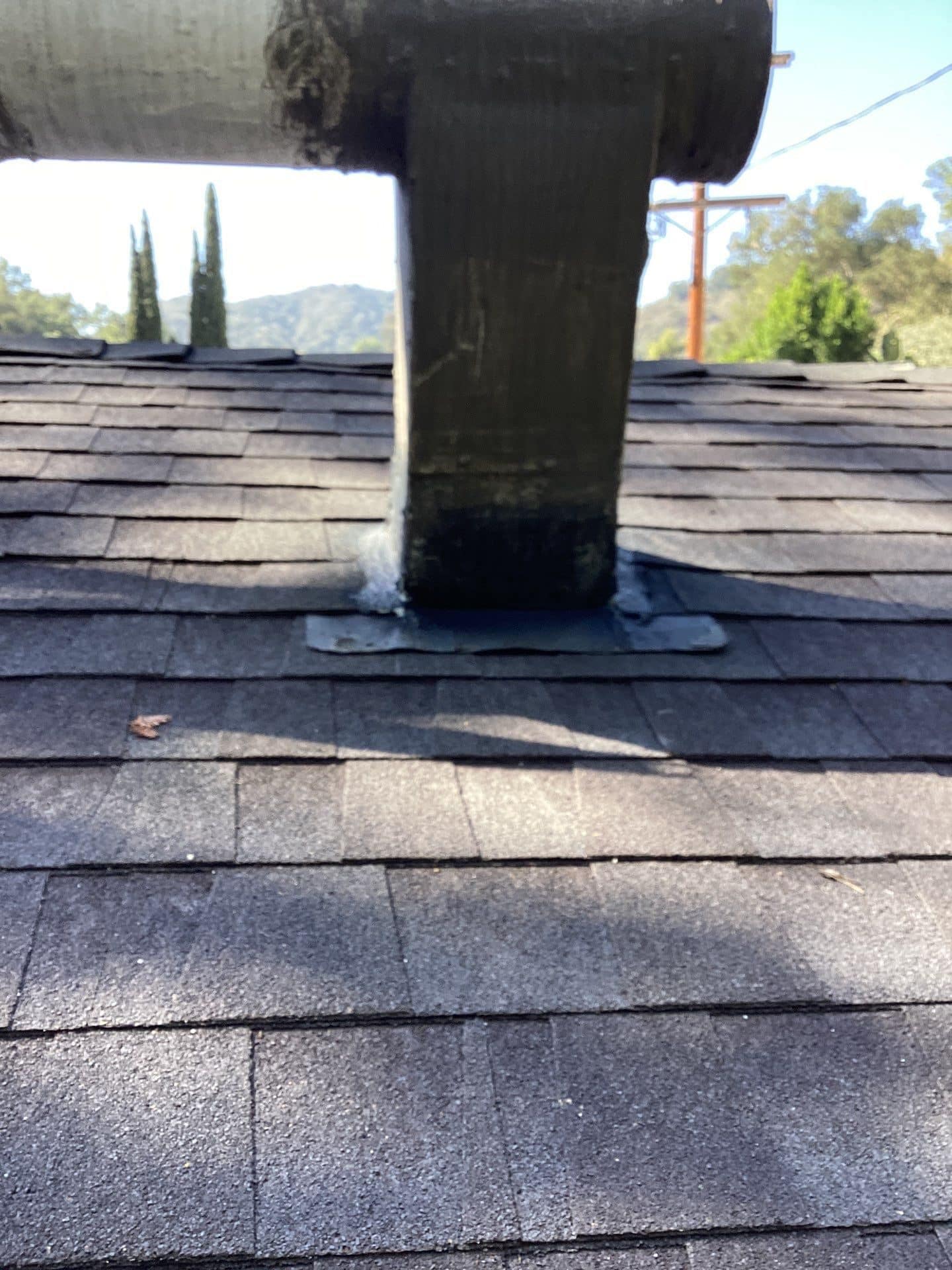 Pipe boot flashing on dark asphalt shingle roof in Beverly Hills | Roof Replacement Inc Pipe boot flashing on dark asphalt shingle roof — Beverly Hills — Roof Replacement Inc