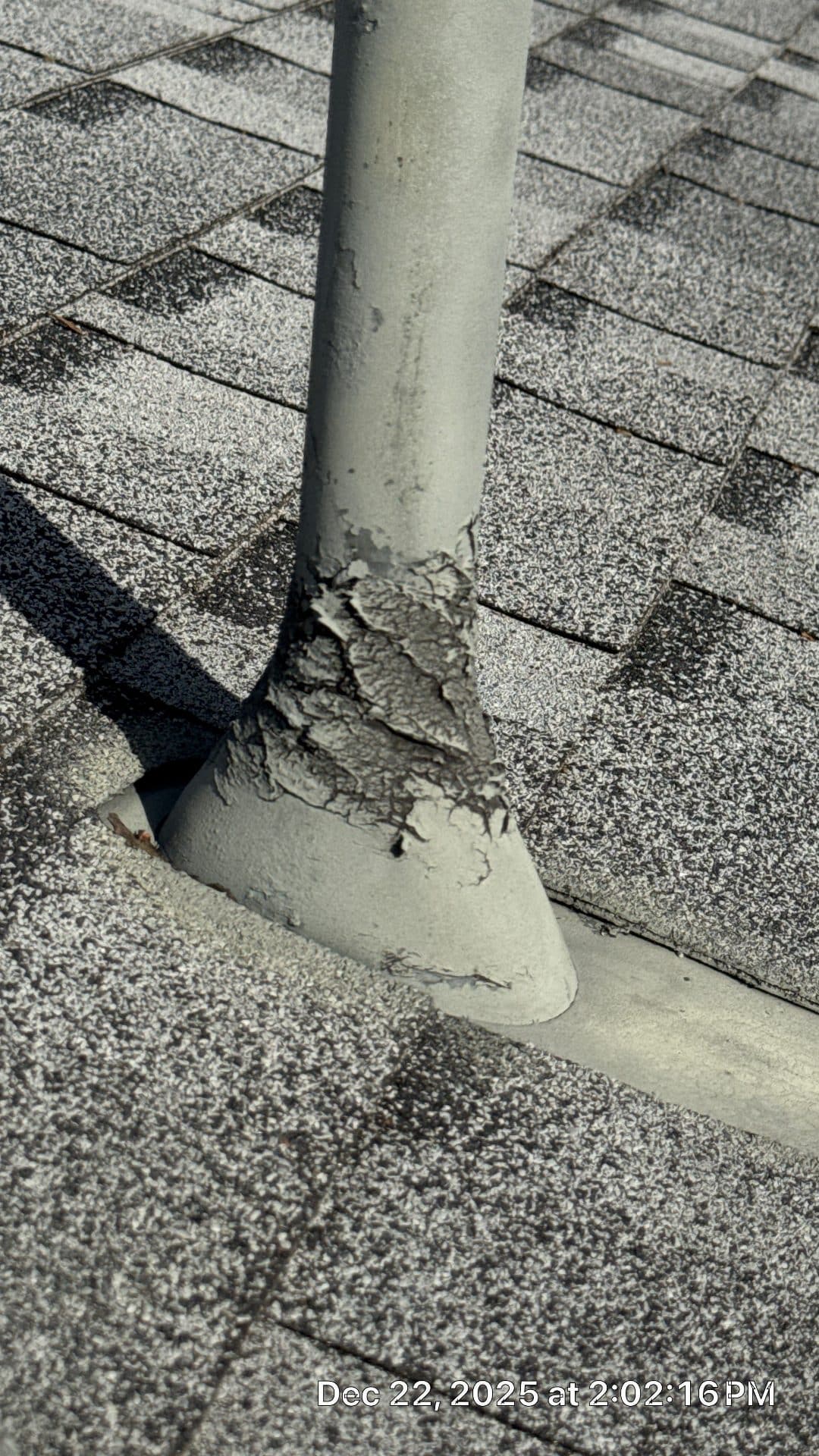 Failed pipe boot flashing with cracked sealant on asphalt shingles — Studio City — Roof Replacement Inc