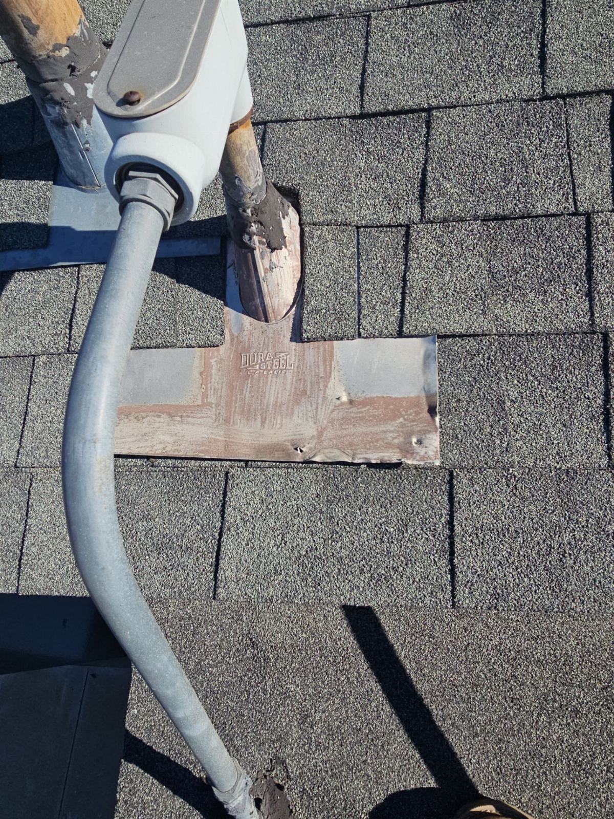 Rusted pipe flashing boot on asphalt shingle roof with conduit in Panorama City | Roof Replacement Inc Rusted pipe flashing boot on asphalt shingle roof with conduit — Panorama City — Roof Replacement Inc