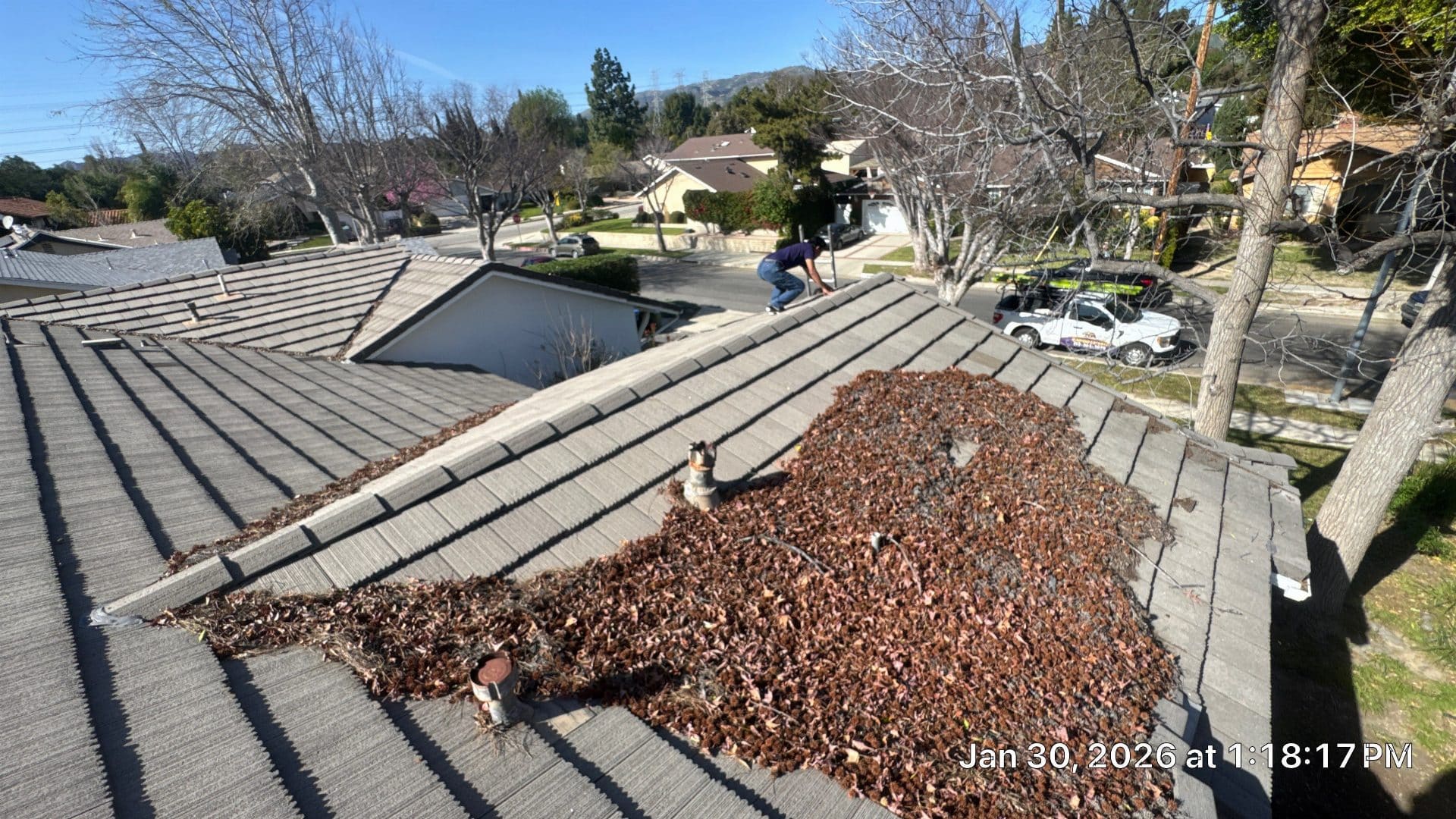 Tile roof with heavy leaf debris accumulation near pipe penetrations in Granada Hills | Roof Replacement Inc Tile roof with heavy leaf debris accumulation near pipe penetrations — Granada Hills — Roof Replacement Inc
