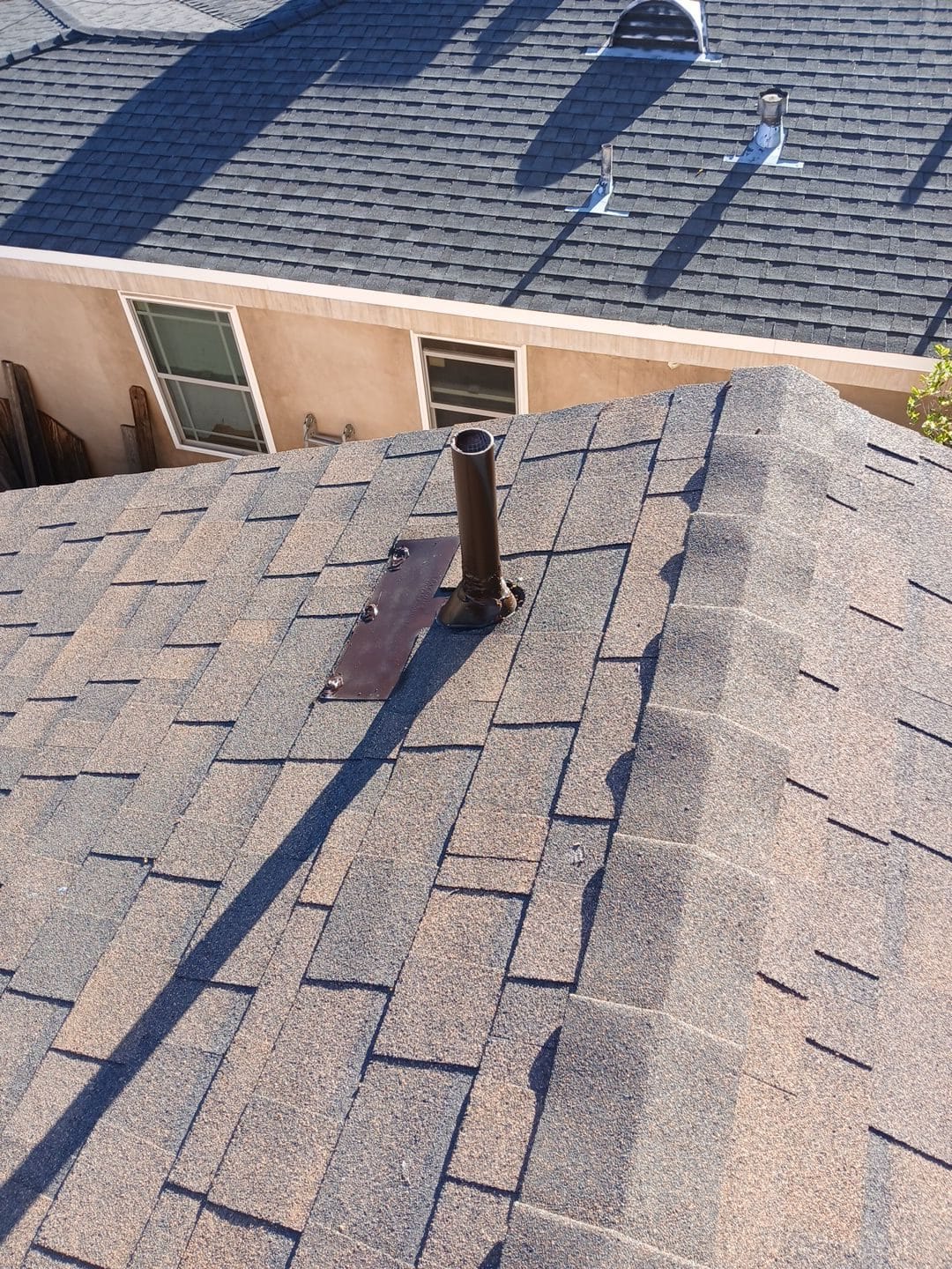 Asphalt shingle roof with plumbing vent pipe and lead flashing in Van Nuys | Roof Replacement Inc Asphalt shingle roof with plumbing vent pipe and lead flashing — Van Nuys — Roof Replacement Inc