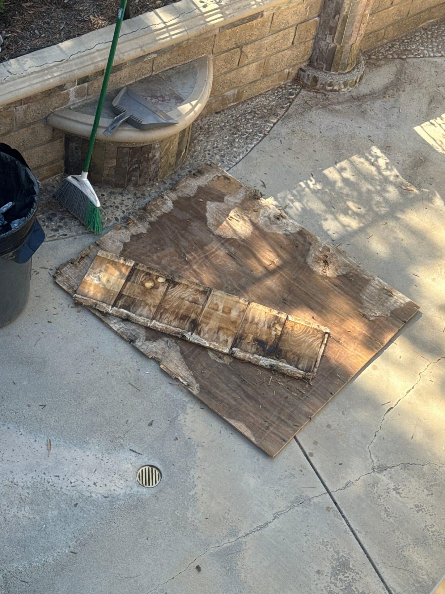 Damaged wood sheathing and shingles removed, laid on concrete in Santa Clarita | Roof Replacement Inc Damaged wood sheathing and shingles removed, laid on concrete — Santa Clarita — Roof Replacement Inc