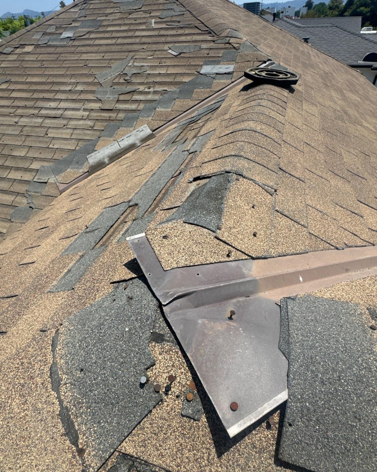 Detail of the old valley and ridge flashing removed from the roof deck showing rust and separated base plates