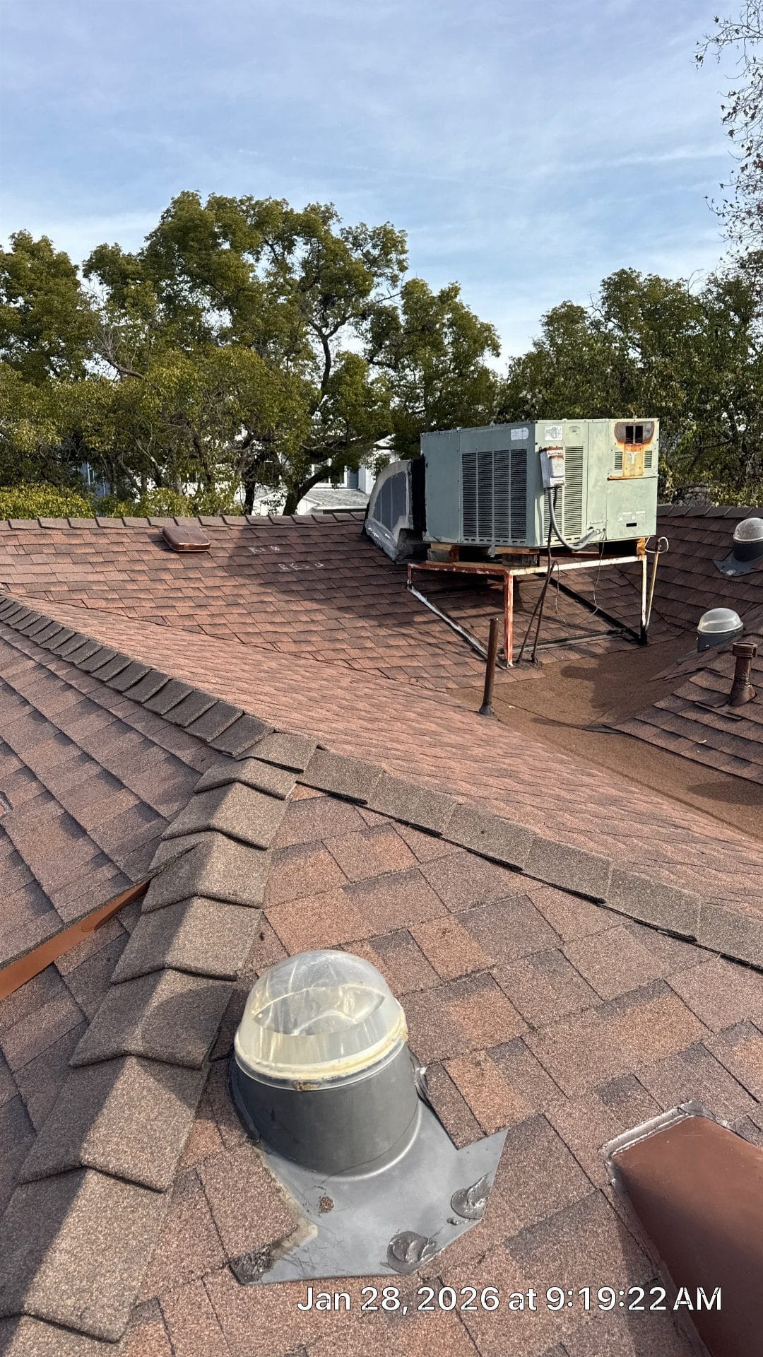 Asphalt shingle roof with tubular skylight, rooftop HVAC unit on rusted curb in Sherman Oaks | Roof Replacement Inc Asphalt shingle roof with tubular skylight, rooftop HVAC unit on rusted curb — Sherman Oaks — Roof Replacement Inc