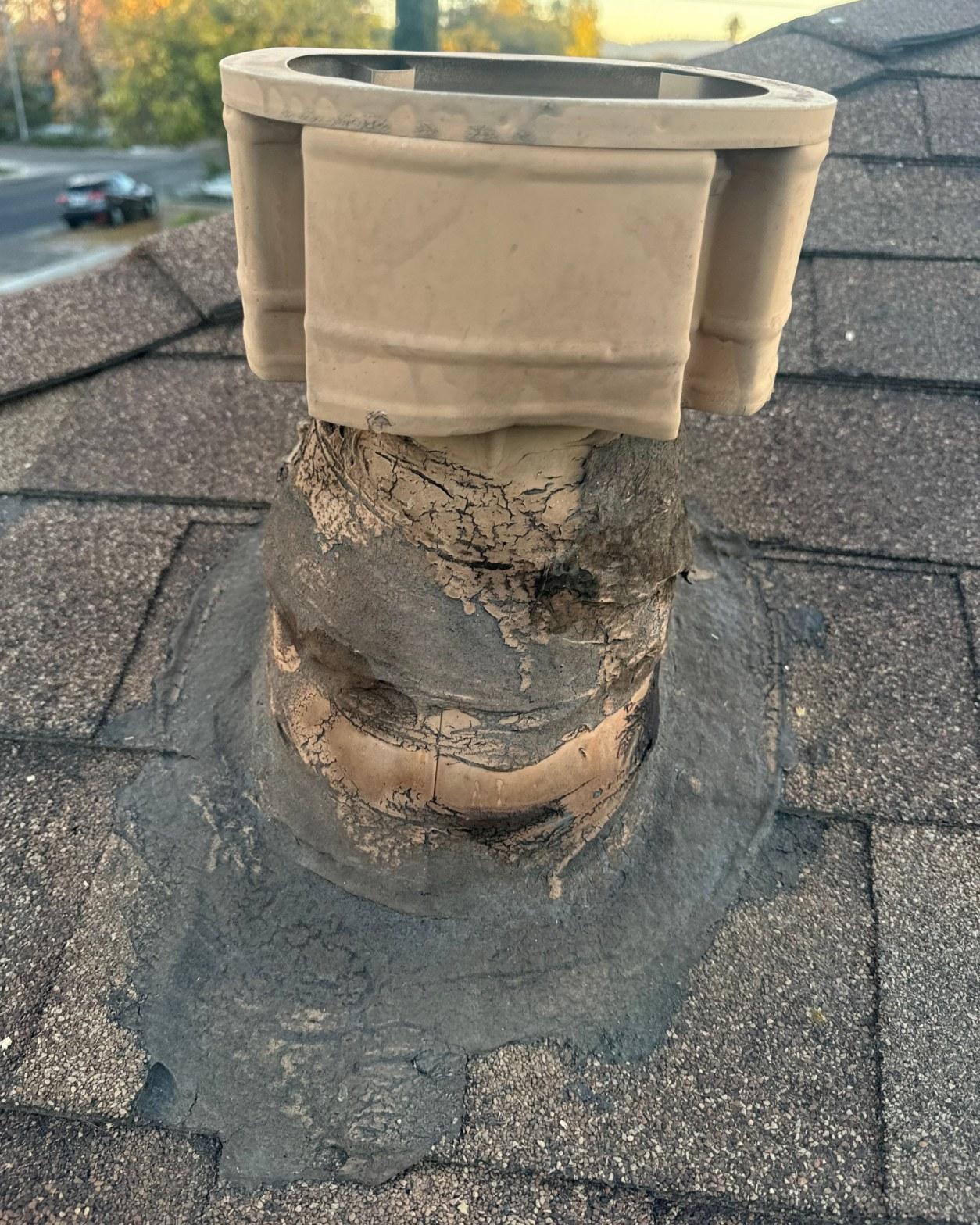 Failed chimney flue collar with cracked elastomeric coating and lifted base flashing on composition shingle roof
