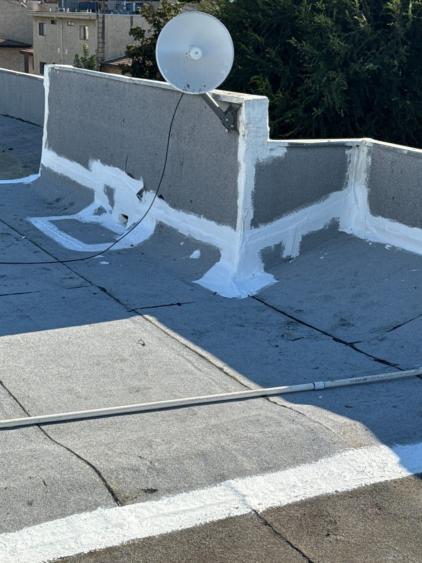 Flat roof with white elastomeric sealant applied to parapet walls and seams — Van Nuys — Roof Replacement Inc