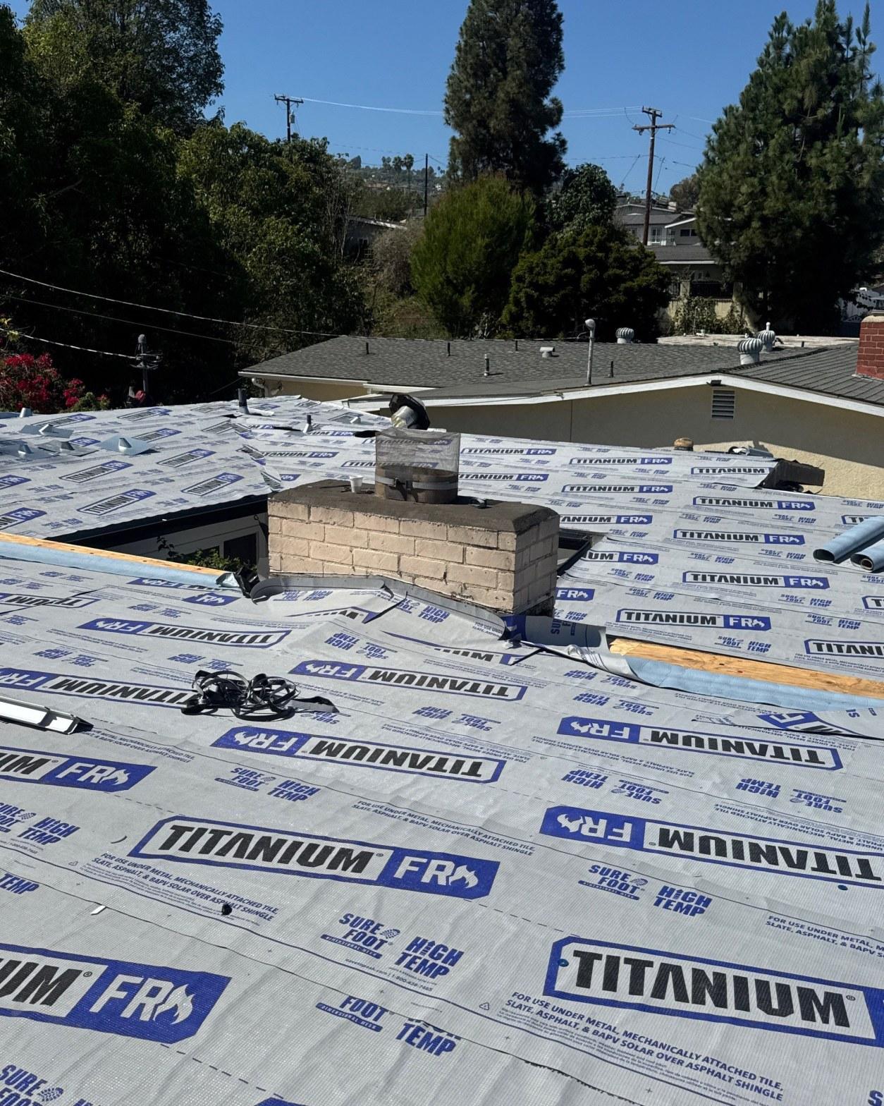 mid-century-home-standing-seam-metal-roof-skip-sheathing-4392 Titanium FR high-temperature synthetic underlayment installed over new plywood deck with chimney and new flashings visible