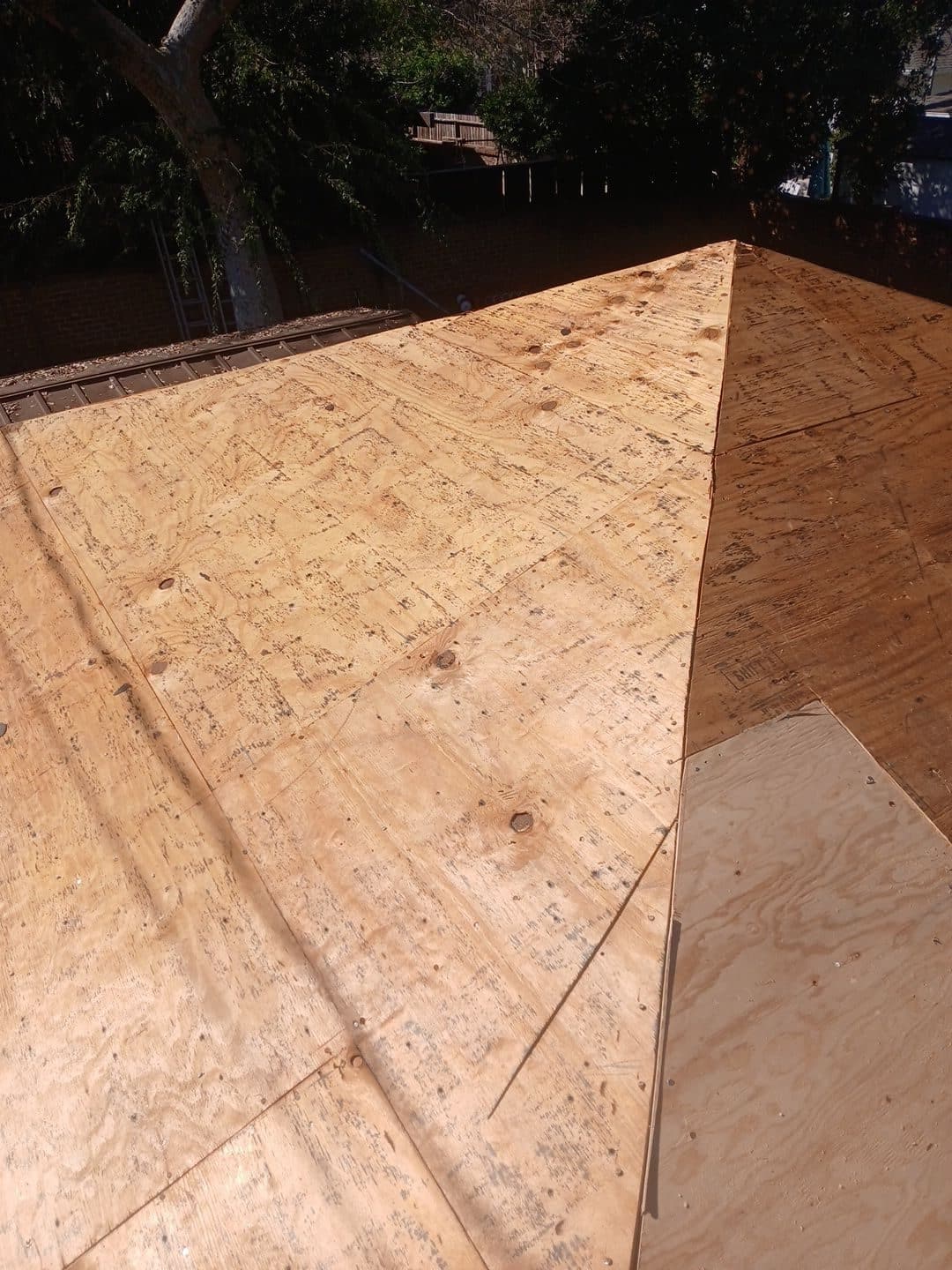 New plywood sheathing installed on hip roof deck — Burbank — Roof Replacement Inc