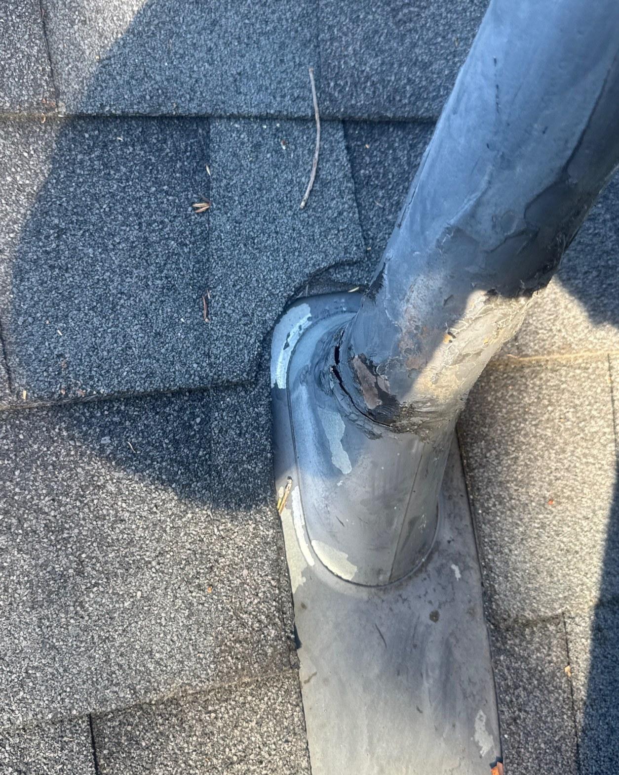 Deteriorated rubber pipe boot with cracked collar pulled away from the vent pipe stack on an asphalt shingle roof